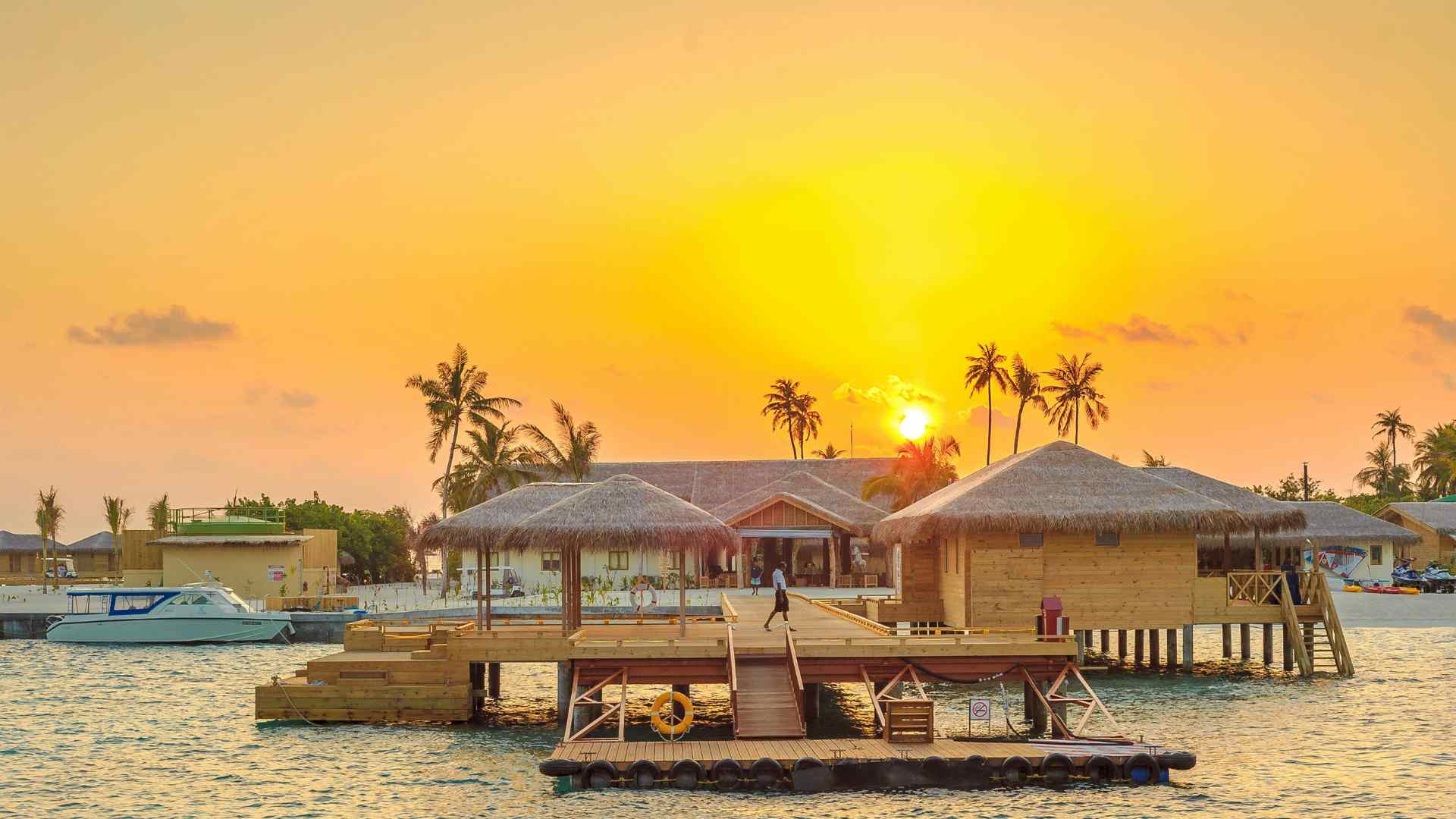 Aerial view of tropical overwater accommodation and a long jetty