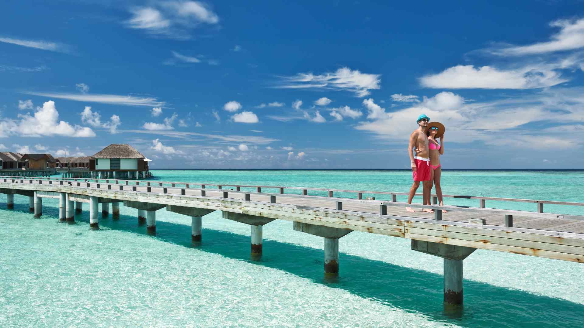 Couple relaxing beside a tropical lagoon