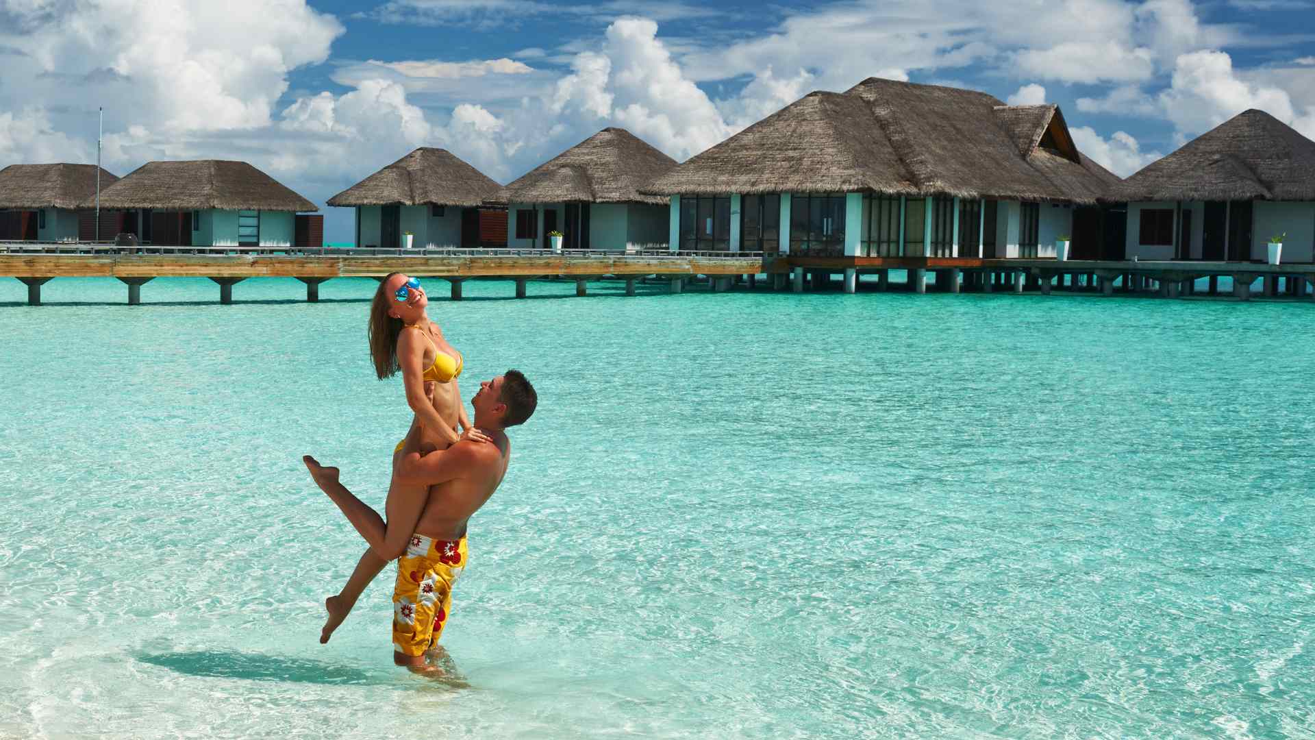 Tropical overwater bungalows above clear turquoise water