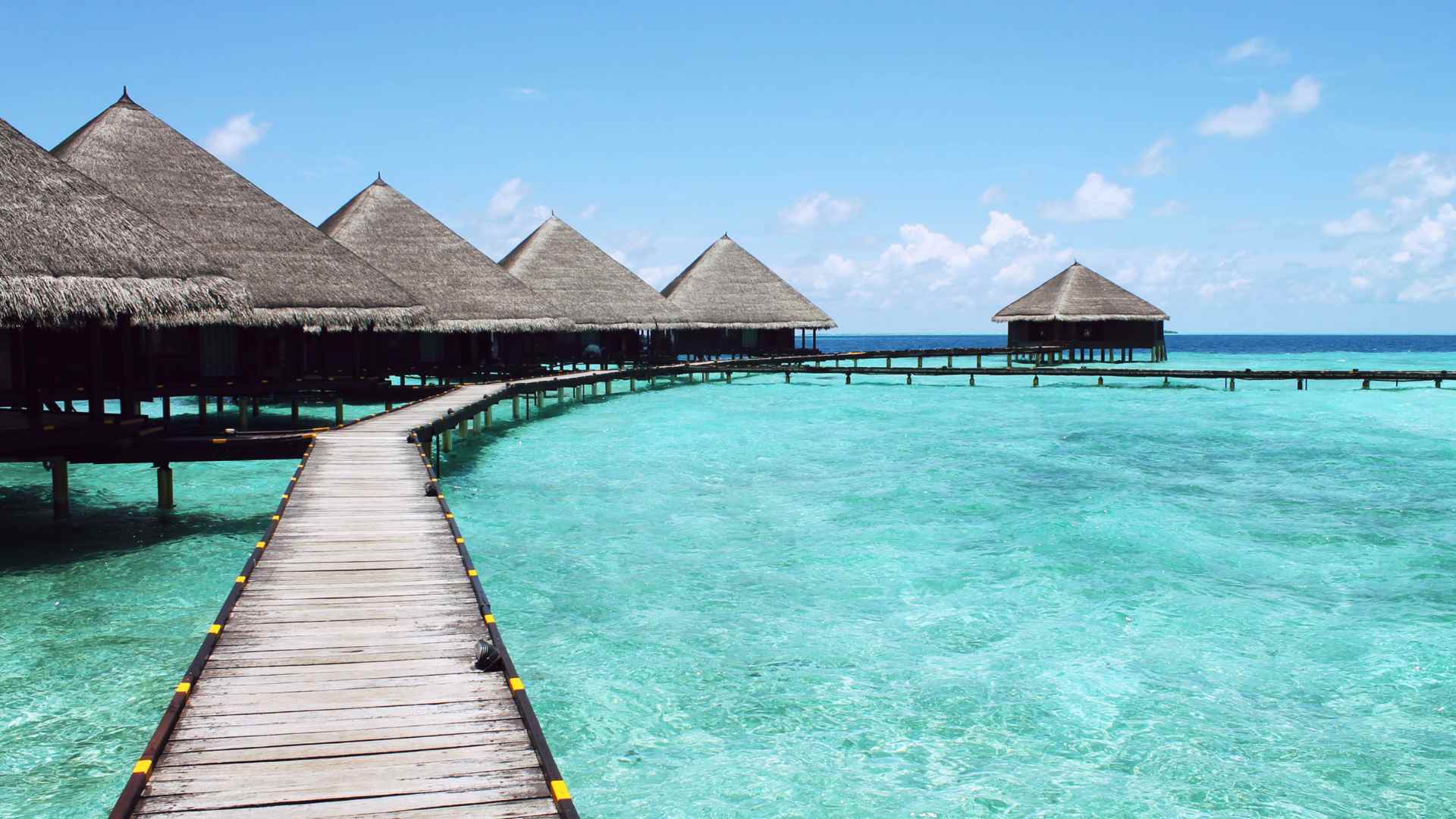 Overwater suites extending from an Antigua beach resort