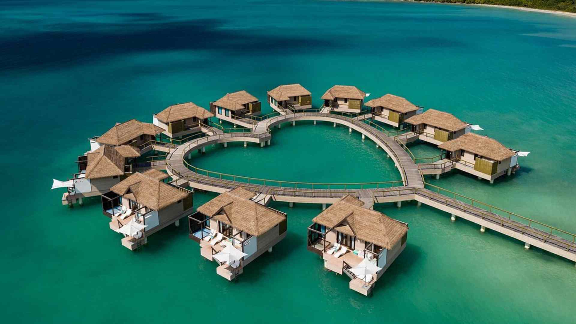 Aerial view of Sandals South Coast overwater bungalows on a heart-shaped jetty