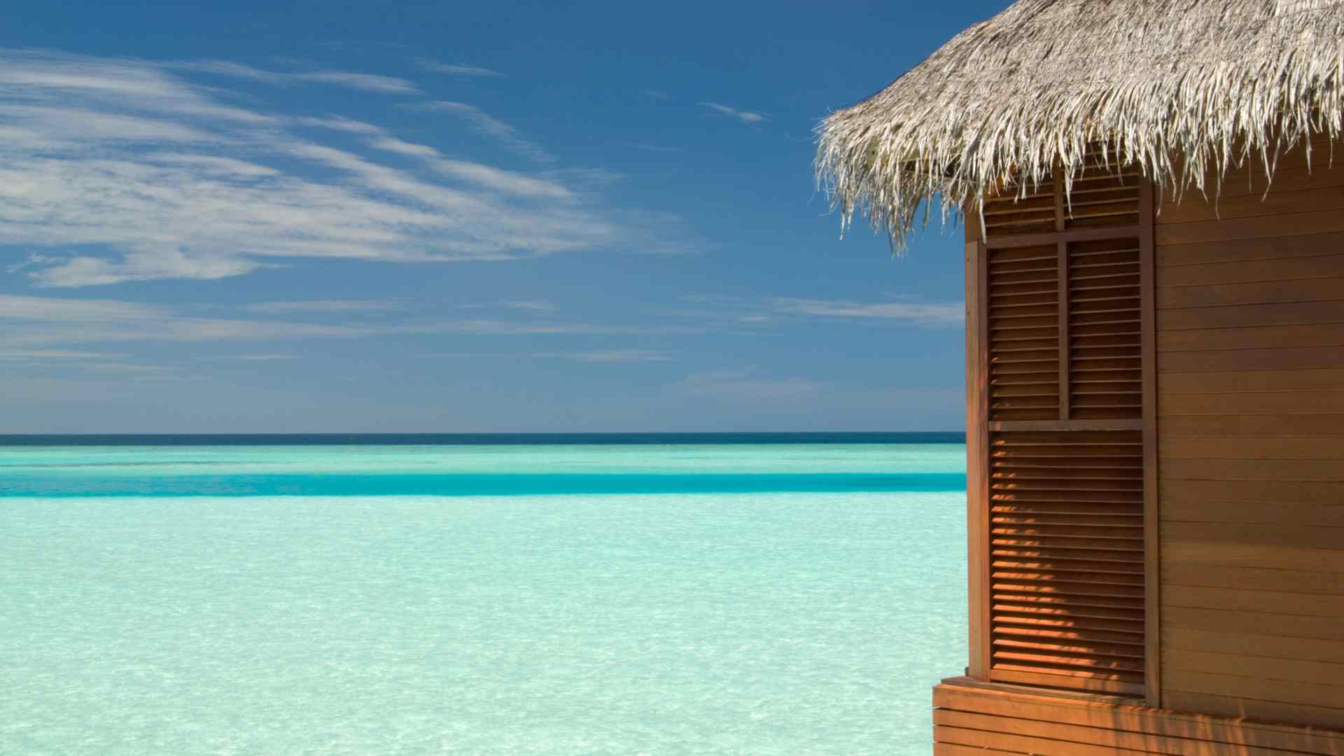 Wooden overwater bungalow with a private deck above a lagoon