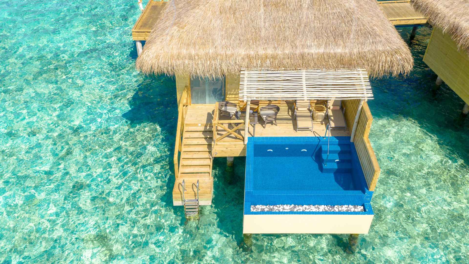 Classic Sandals overwater bungalow with a private deck and hammock