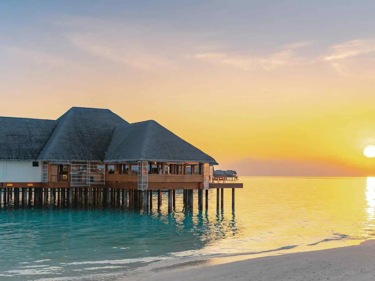 An overwater retreat beside clear water in Africa