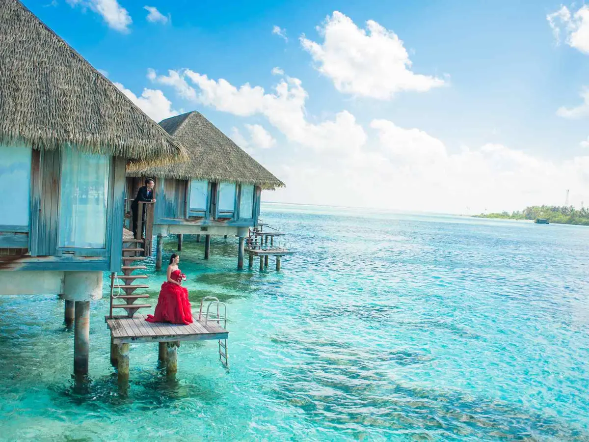 A boardwalk leading to overwater bungalows in Southeast Asia