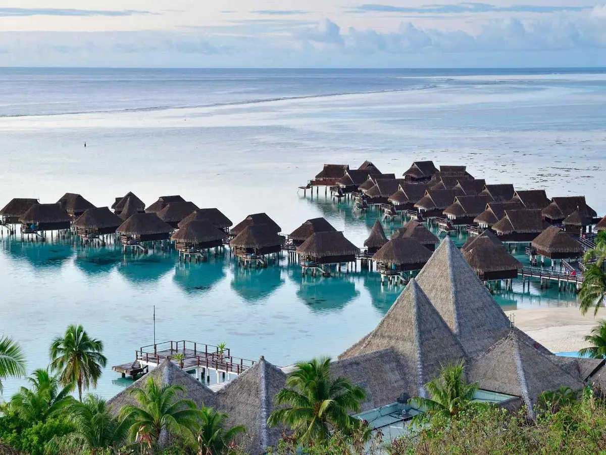 Overwater villas beside a turquoise tropical lagoon