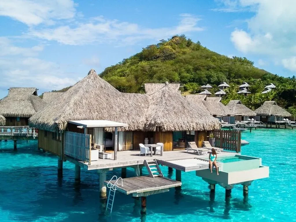 Le Bora Bora overwater bungalow with private pool above a bright blue lagoon