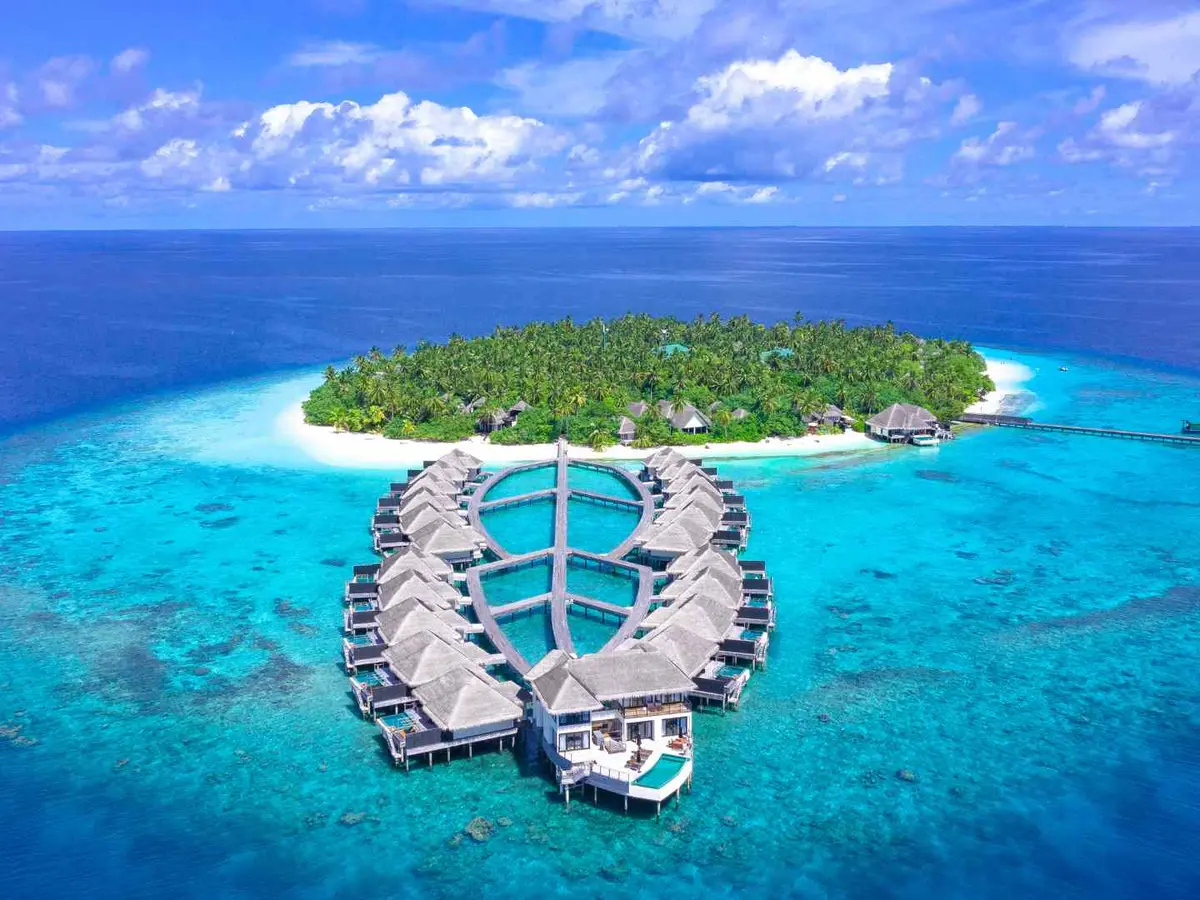 Water villas extending above a turquoise Maldives lagoon
