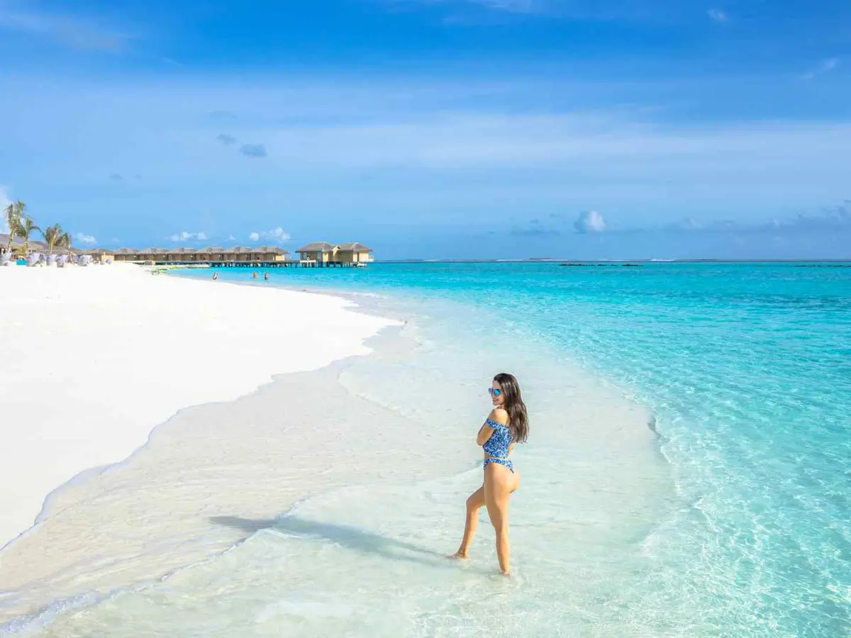 Overwater villas beside a blue Middle Eastern lagoon