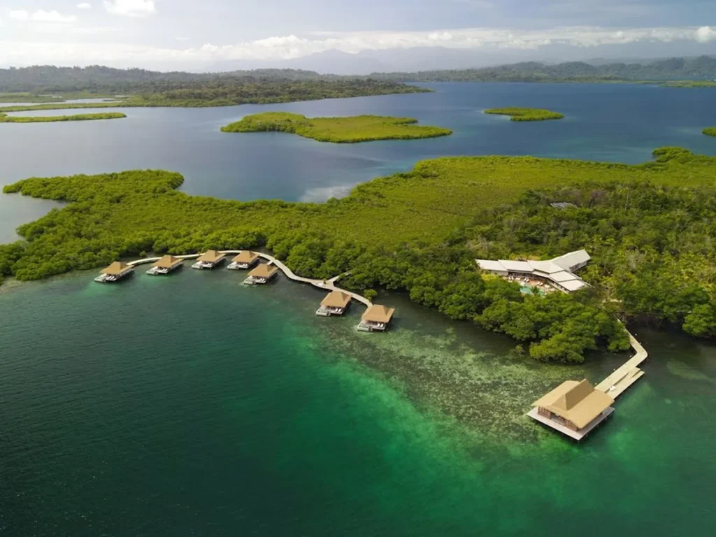 Aerial view of Nayara Bocas del Toro villas beside mangroves and calm water